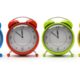 Four colourful alarm clocks isolated on white background 3D