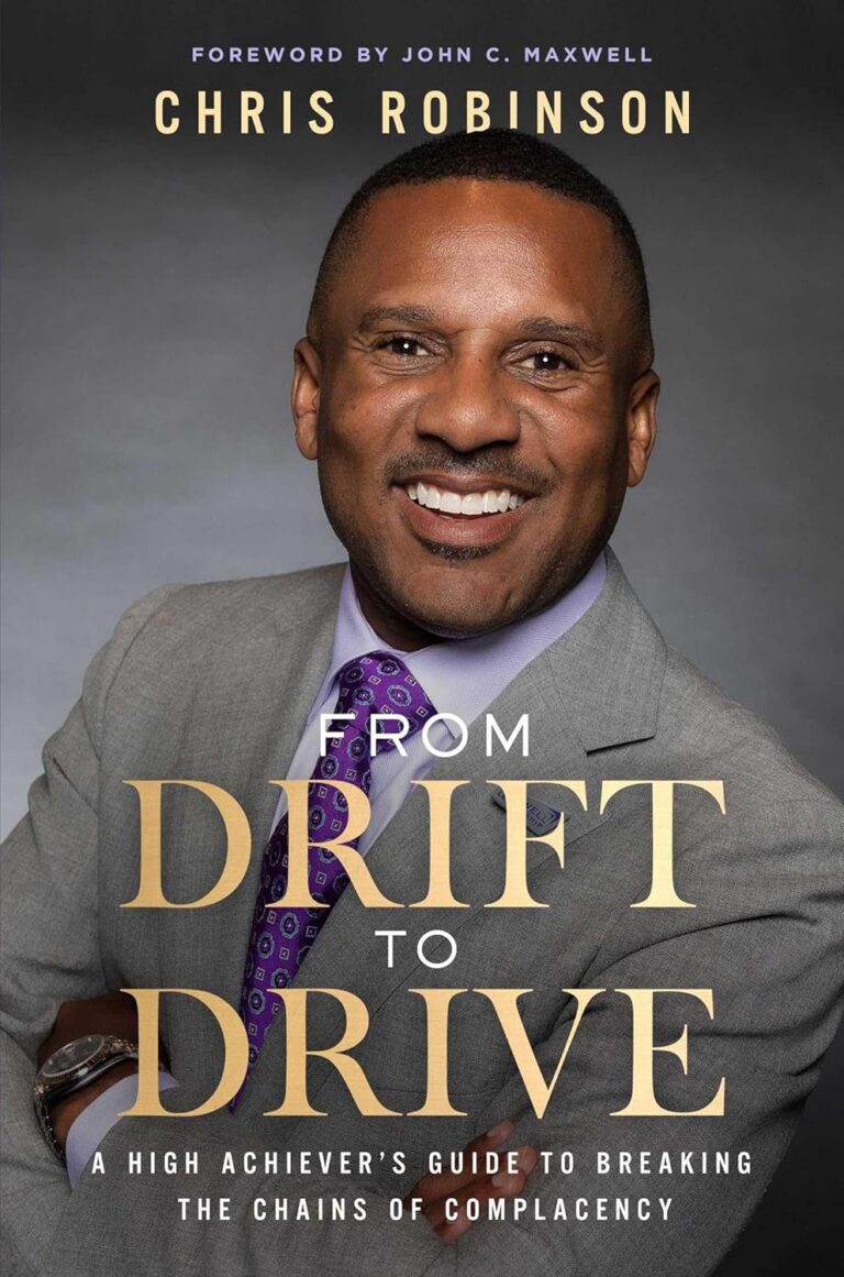 A smiling man in a suit with folded arms appears on the cover of Onyx Storm: From Drift to Drive—A High Achievers Guide to Breaking the Chains of Complacency by Chris Robinson.