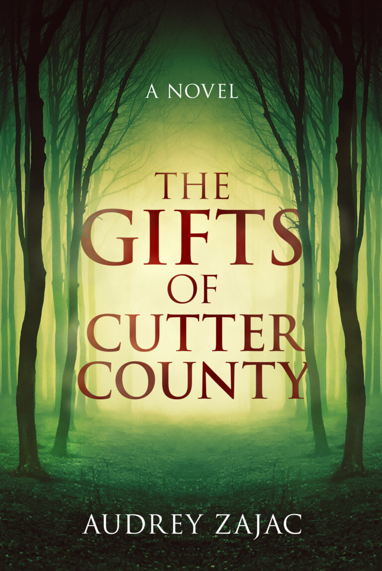 Book cover for The Gifts of Cutter County by Audrey Zajac. The title appears in large red letters over a misty, green forest in Cutter County, with tall, bare trees and a glowing light hinting at hidden gifts in the background.