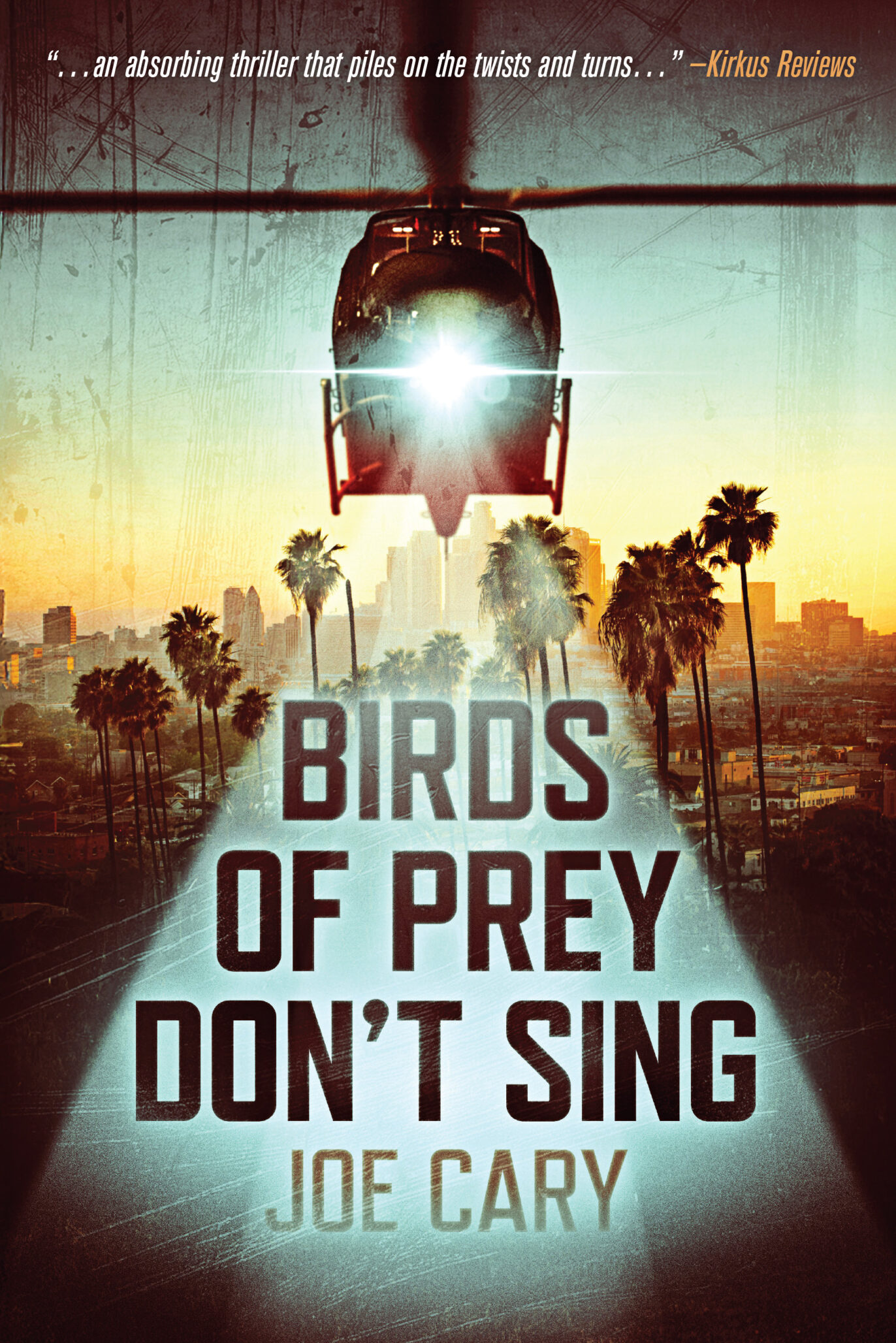 A helicopter shines a spotlight over palm trees and a city skyline at sunset. Large bold text reads BIRDS OF PREY DON’T SING with JOE CARY beneath, hinting that not all birds—or their prey—find their voice. A review quote appears at the top.