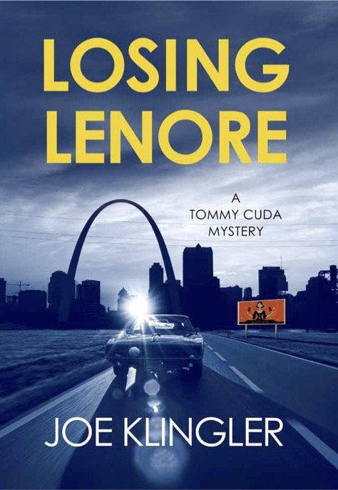A car drives toward the St. Louis Gateway Arch at dusk under a cloudy sky. A billboard with a silhouetted figure advertises the gripping thriller Losing Lenore, with bold yellow text and author Joe Klingler's name.